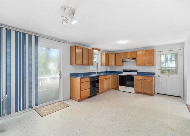 kitchen featuring electric range, dishwasher, under cabinet range hood, dark countertops, and a sink