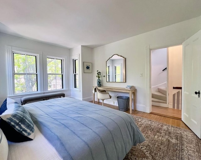 bedroom featuring wood finished floors and baseboards