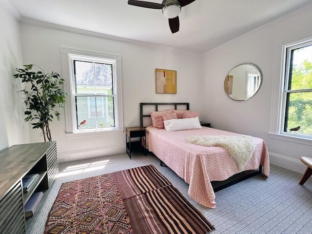 bedroom featuring carpet, ornamental molding, a ceiling fan, and baseboards