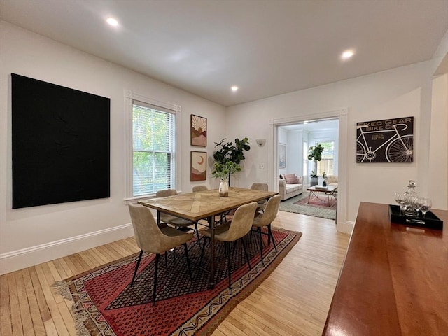 dining room with light wood finished floors, recessed lighting, and baseboards