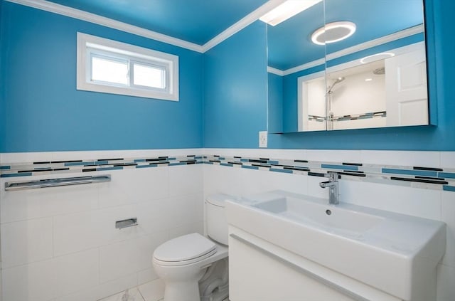 bathroom featuring tile walls, toilet, vanity, and crown molding