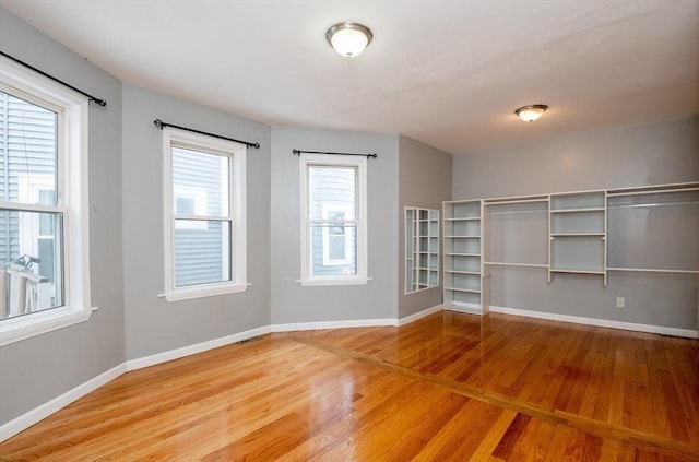 empty room with hardwood / wood-style floors