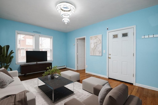 living room with a baseboard radiator and wood-type flooring