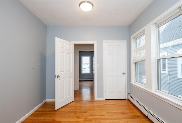 interior space featuring light hardwood / wood-style flooring and baseboard heating