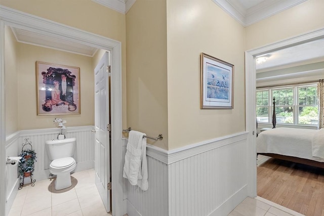 22 Hummock Way Unit 22, Hudson, MA 01749 - bathroom featuring ornamental molding, toilet, wainscoting, tile patterned floors, and ensuite bathroom