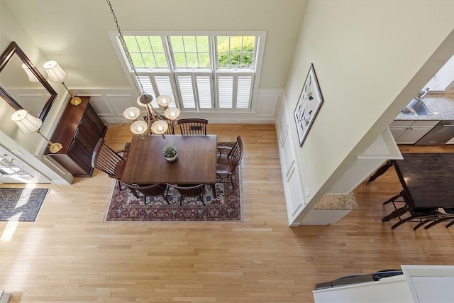 22 Hummock Way Unit 22, Hudson, MA 01749 - dining area with wainscoting, a decorative wall, a chandelier, and wood finished floors