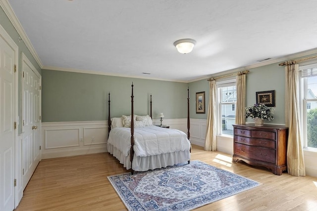 22 Hummock Way Unit 22, Hudson, MA 01749 - bedroom with light wood finished floors, wainscoting, a decorative wall, and ornamental molding