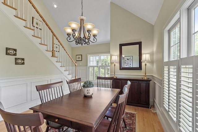 22 Hummock Way Unit 22, Hudson, MA 01749 - dining area featuring a decorative wall, light wood-style flooring, a wainscoted wall, stairs, and a chandelier