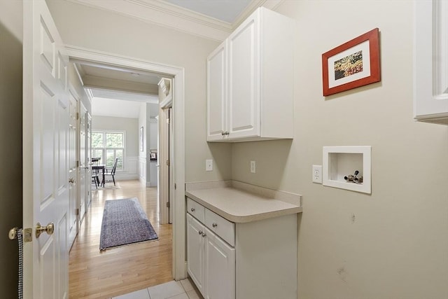 22 Hummock Way Unit 22, Hudson, MA 01749 - washroom featuring washer hookup, cabinet space, and ornamental molding