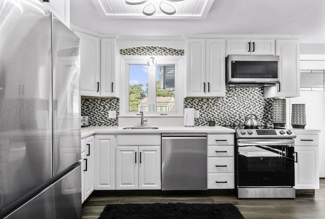 kitchen featuring white cabinetry, stainless steel appliances, tasteful backsplash, sink, and dark hardwood / wood-style floors