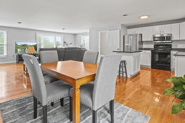 60 Mahogany Run Unit 60, Leominster, MA 01453 - dining area with light wood-style flooring and baseboards