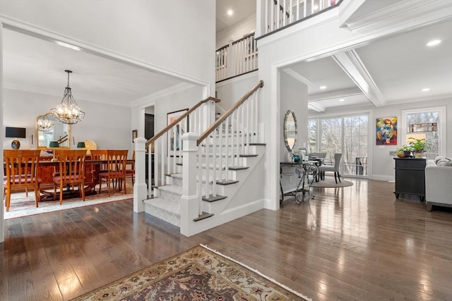 foyer with baseboards, stairs, ornamental molding, and hardwood / wood-style floors