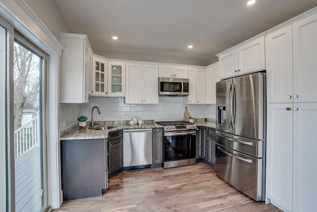 136 Flash Rd Townhome, Unit Townhome, Nahant, MA 01908 - kitchen with a sink, white cabinets, light stone counters, and stainless steel appliances