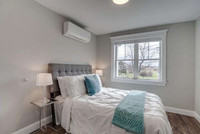 136 Flash Rd Townhome, Unit Townhome, Nahant, MA 01908 - bedroom featuring wood finished floors, a wall mounted air conditioner, and baseboards