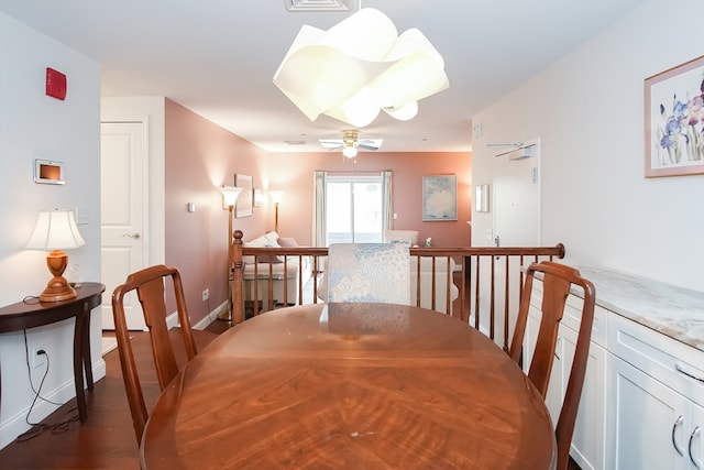 dining room with ceiling fan and dark hardwood / wood-style floors