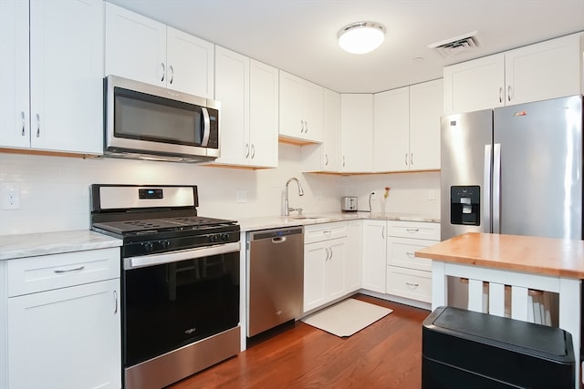 kitchen featuring white cabinetry, dark hardwood / wood-style floors, and stainless steel appliances