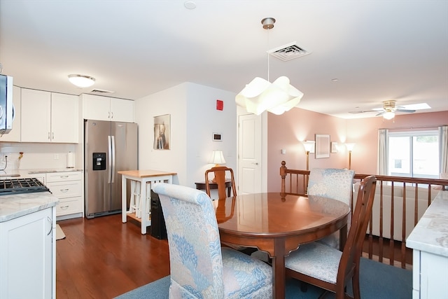 dining space with dark hardwood / wood-style flooring and ceiling fan