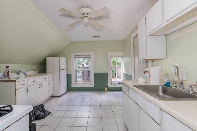 26 Hawthorne St, Brockton, MA 02301 - kitchen with white appliances, a sink, white cabinets, light countertops, and vaulted ceiling