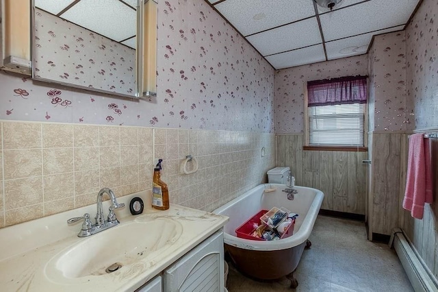 26 Hawthorne St, Brockton, MA 02301 - full bath featuring wallpapered walls, a baseboard heating unit, a wainscoted wall, a soaking tub, and vanity