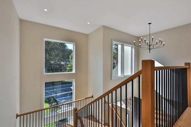 stairs with a chandelier