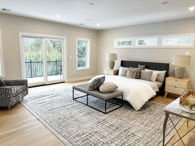 bedroom featuring light wood-type flooring and access to outside