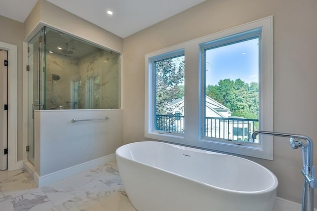 bathroom featuring separate shower and tub