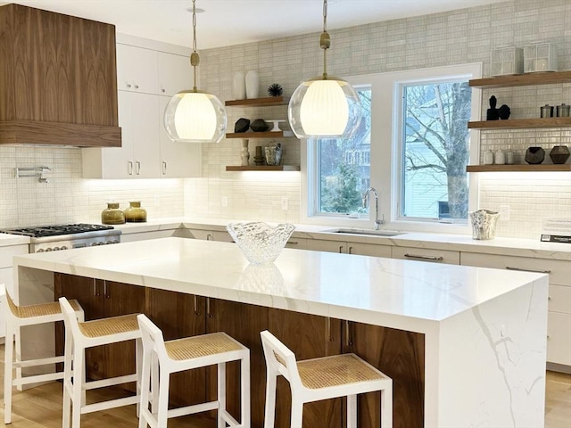 kitchen featuring pendant lighting, sink, and a kitchen breakfast bar