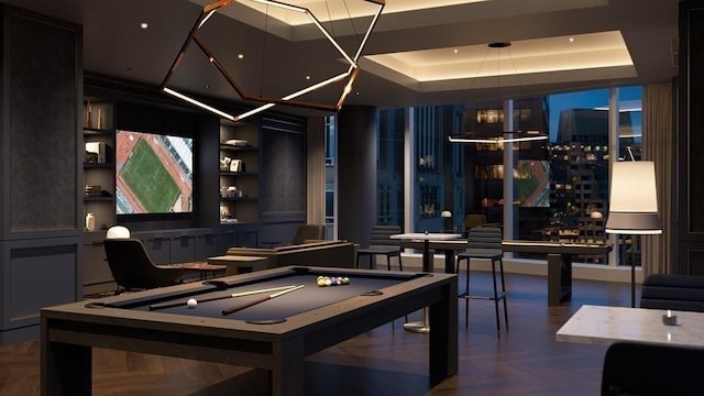 game room featuring a chandelier, a tray ceiling, parquet flooring, and pool table