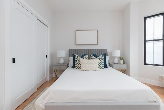 bedroom with a closet and light hardwood / wood-style flooring