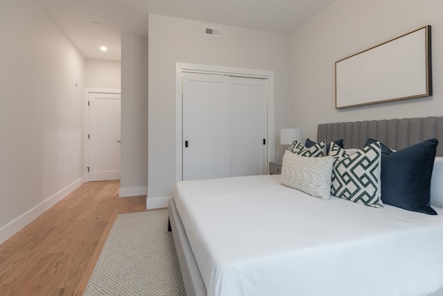 bedroom featuring light wood-type flooring and a closet