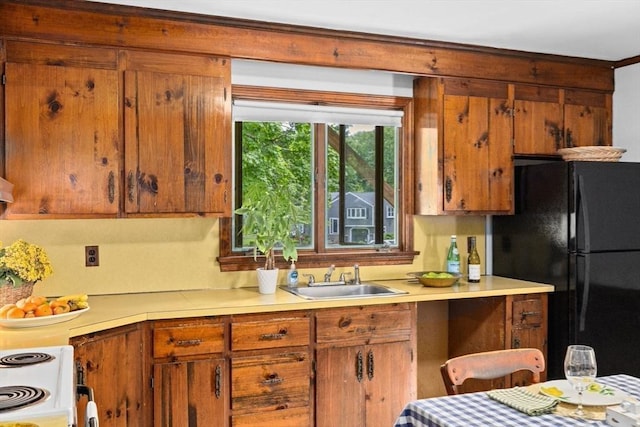 225 Pleasant St, Weymouth, MA 02190 - kitchen featuring a sink, freestanding refrigerator, light countertops, electric range, and brown cabinetry
