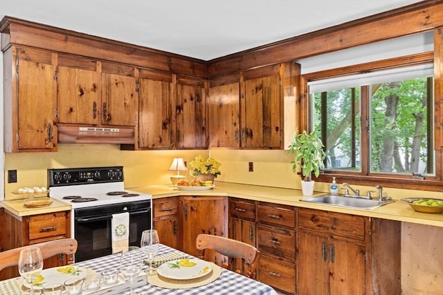 225 Pleasant St, Weymouth, MA 02190 - kitchen with range with electric stovetop, under cabinet range hood, a sink, light countertops, and brown cabinetry