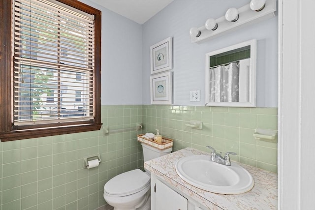225 Pleasant St, Weymouth, MA 02190 - full bathroom with vanity, toilet, tile walls, a shower with shower curtain, and a wainscoted wall