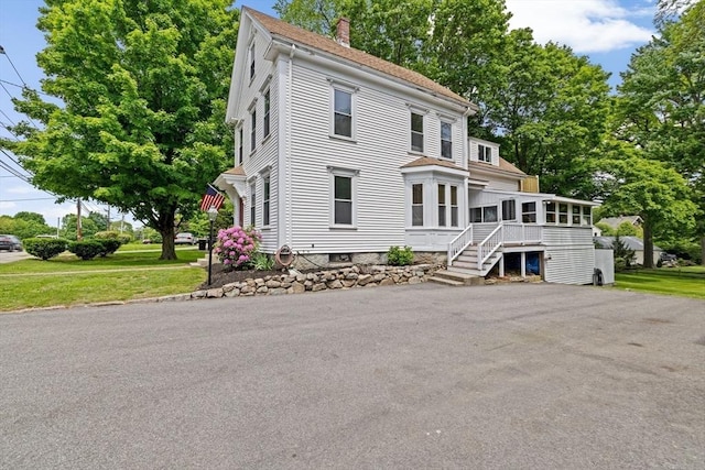 225 Pleasant St, Weymouth, MA 02190 - view of front of house with a sunroom and a chimney