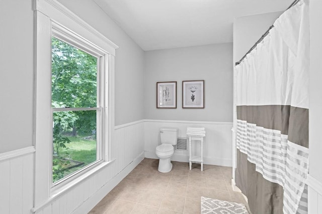 225 Pleasant St, Weymouth, MA 02190 - bathroom with plenty of natural light, tile patterned floors, toilet, and wainscoting