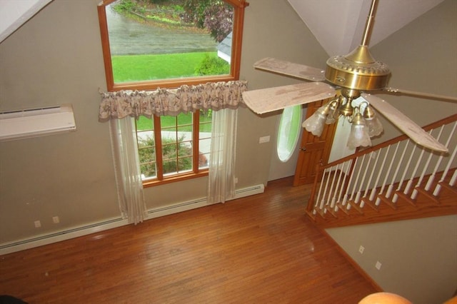 30 Bailey Rd, Oxford, MA 01540 - unfurnished living room featuring wood finished floors, an AC wall unit, vaulted ceiling, and a ceiling fan