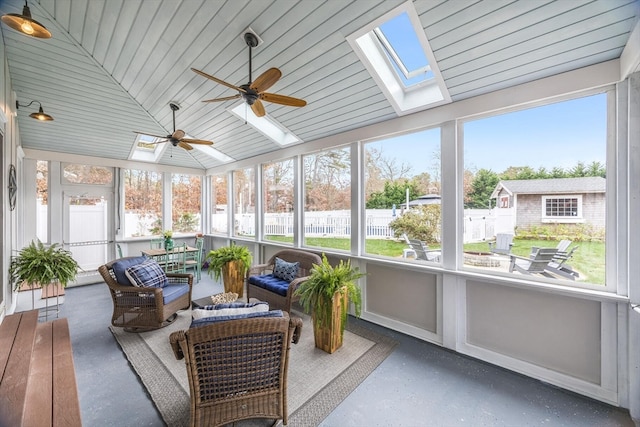 sunroom with plenty of natural light, lofted ceiling, and ceiling fan