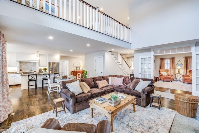 living room with a high ceiling and hardwood / wood-style floors