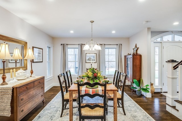 dining space featuring dark hardwood / wood-style floors and an inviting chandelier