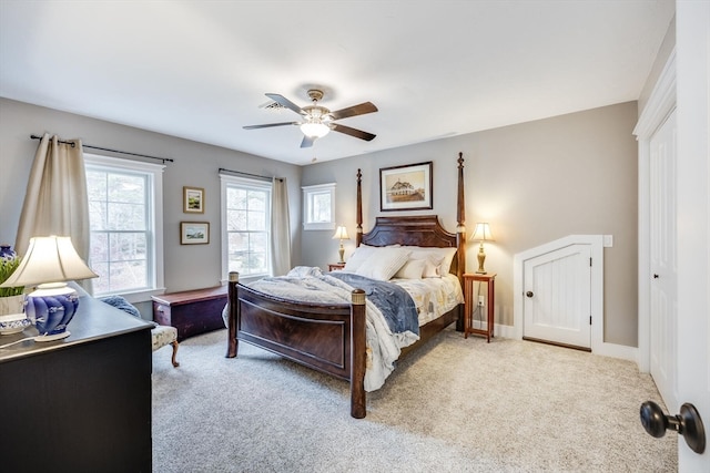 carpeted bedroom featuring ceiling fan and a closet