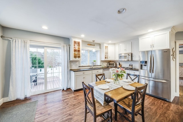 dining room with sink and dark wood-type flooring