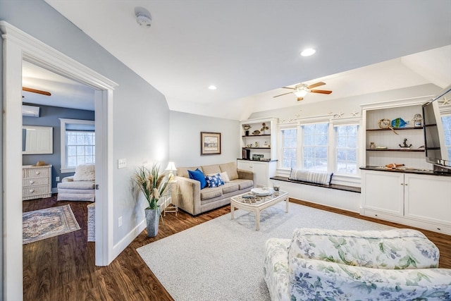 living room featuring ceiling fan, dark wood-type flooring, and a wealth of natural light