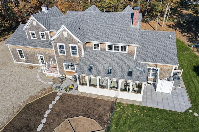 back of house with a patio area and a sunroom