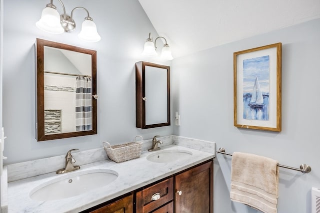 bathroom featuring a shower with curtain, vanity, and lofted ceiling