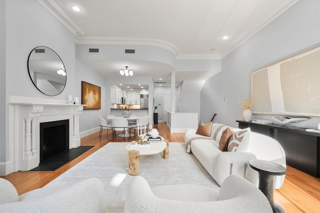 living room featuring light hardwood / wood-style floors and ornamental molding