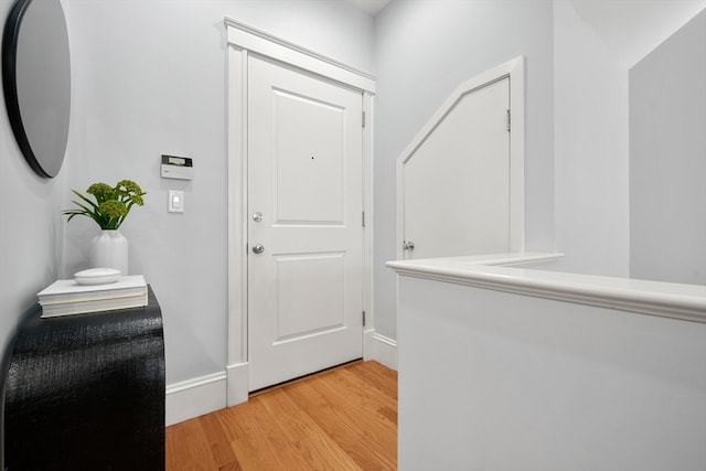 corridor with light hardwood / wood-style floors