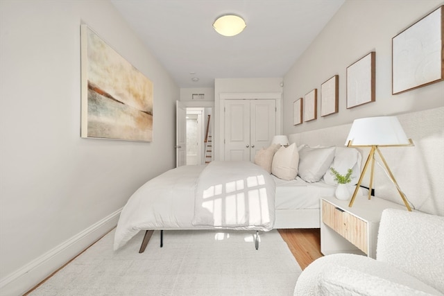 bedroom featuring light wood-type flooring and a closet