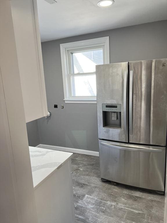 kitchen with stainless steel refrigerator with ice dispenser and hardwood / wood-style flooring