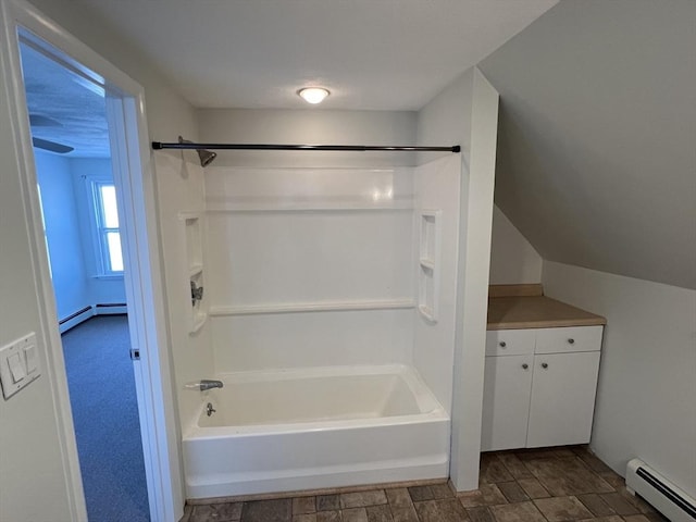 bathroom with shower / tub combination and a baseboard heating unit