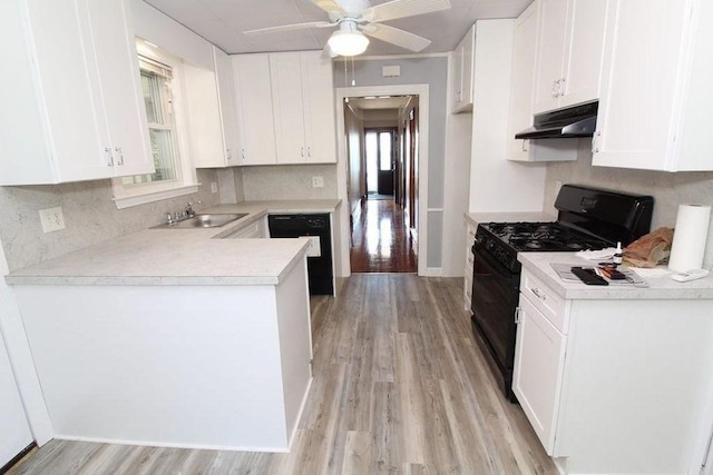 kitchen featuring light hardwood / wood-style floors, sink, white cabinetry, and black appliances